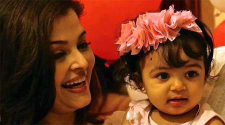 Aaradhya introduced to writing on Saraswati Puja 