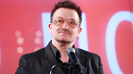 Bono prays with family on bed