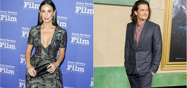 Orlando Bloom and Demi Moore are practising yoga moves on each other